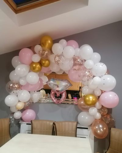 pink, white and god balloon arch with engagement ring shaped balloon in the middle set up by Gizmo Balloons in Dublin, Ireland